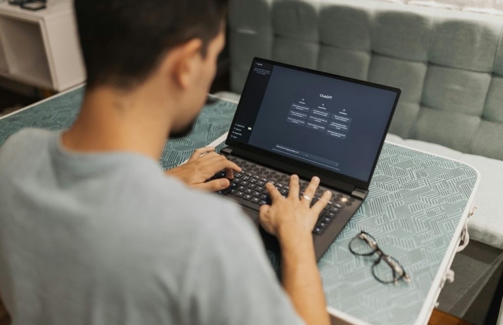 Someone entering code on a laptop