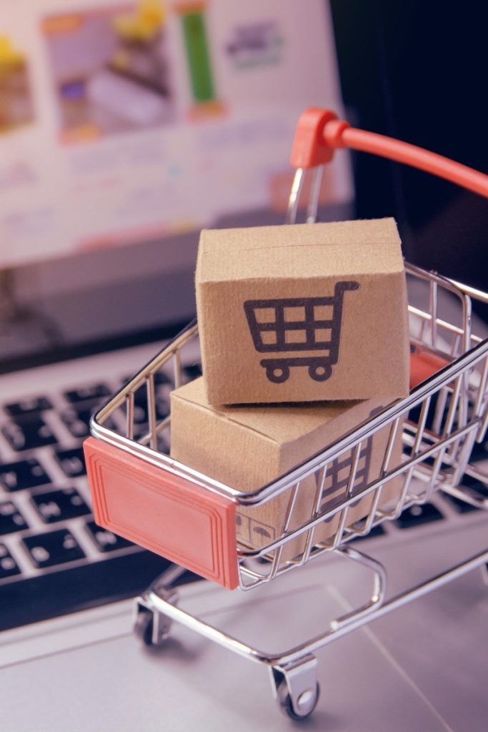 Small cart with packages sitting on laptop keys